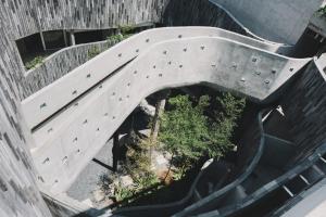 an overhead view of a concrete staircase with plants at Lloyd's Inn Bali in Seminyak