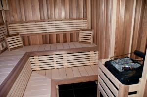 a sauna with a bench and a tub in it at Hotel u Ledu in Velké Popovice