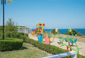 a park with a playground with the ocean in the background at HOTEL ESKADA BEACH - Free Parking in Ahtopol