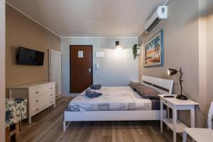 a bedroom with a bed and a desk and a tv at CconfortHotels R&B Cavour - SELF CHECK IN in Bari
