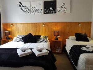 a hotel room with two beds with towels on them at Abisko Lodge in Methven