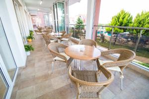 a row of tables and chairs on a balcony at Hotel Sunny in Sozopol