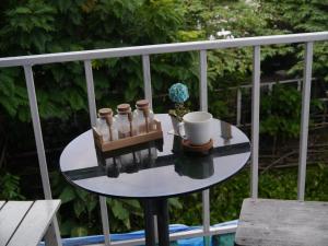 a table with a coffee mug and a cup at New Phiman Riverview Guesthouse in Bangkok