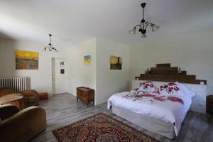 a bedroom with a bed and a living room at Domaine Du Moulin Neuf in Ambillou