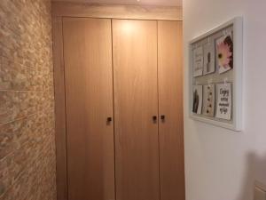 a room with two wooden cabinets and a wall at Nowy Apartament CENTRUM - faktura VAT in Włodawa
