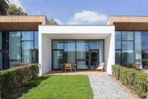 a house with glass doors and a lawn at Quinta de Santa Clara in Ponta Delgada