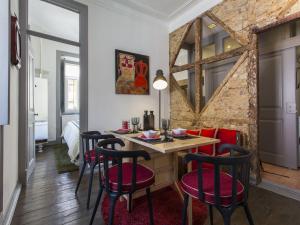 a dining room with a table with red chairs at Historical Lisbon Apartments in Lisbon