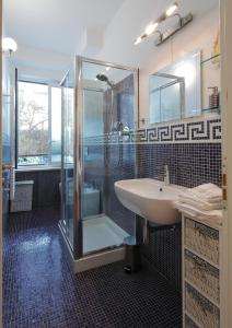 a bathroom with a glass shower and a sink at Bologna Central Apartment in Bologna