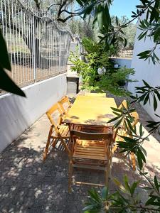 d'une table et de chaises en bois sur un balcon. dans l'établissement VillaOlivara, à Pizzo
