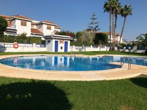 a large swimming pool in the middle of a yard at Duplex Vera - Playa in Vera