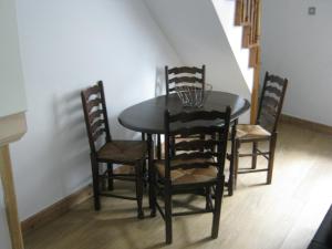 a dining room table with four chairs and a table and a table and chairsktop at Drovers Cottage in Hayfield