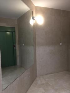 a bathroom with a mirror and a green door at Amiga in Alicante +14 photos