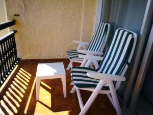 two chairs and a table on a balcony at Miraverde Bright studio with Great Views in Adeje