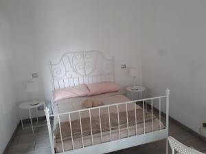 a bed with a white bedspread and pillows at La casa di Mango e Pistacchio in Segrate