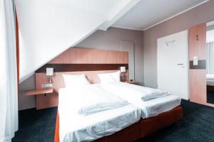 Voodi või voodid majutusasutuse Hotel am Rothenbaum toas