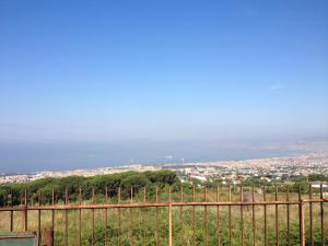 a fence with a view of a city at La Casuccia in Ercolano