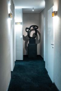 a hallway with a large sculpture on the wall at Hotel am Rothenbaum in Hamburg