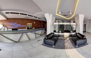 a lobby with leather chairs and a waiting room at STEELHOUSE Hotel in Třinec