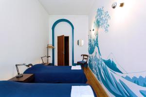 ein Schlafzimmer mit 2 Betten und einem Wandgemälde in der Unterkunft Lost Lisbon :: Chiado House in Lissabon