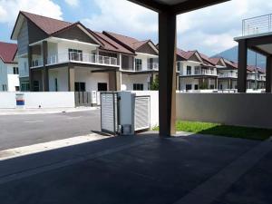 an object sitting in the middle of a parking lot with houses at Greenville Homestay in Balik Pulau