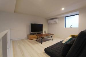 a living room with a couch and a flat screen tv at Shibuya Anon #B102 in Tokyo