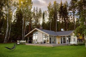 a house in the middle of a green field at Silene Resort & Spa in Silene