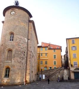 a building with a clock tower next to some buildings at Studios des Templiers in Hyères