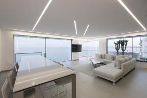 a living room with a couch and a table at Infinity Sea View Apartment in Thessaloniki
