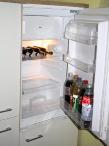 an open refrigerator with bottles of alcohol in it at Ferienwohnung Golden Lotus in Neuwied