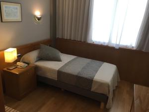 Ένα ή περισσότερα κρεβάτια σε δωμάτιο στο Encasa Hotel Almansa