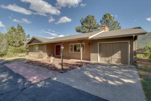 a house with a garage and a driveway at Cottage of Course - Permit #3092 in Estes Park