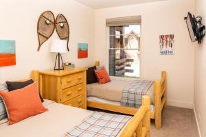 a bedroom with two beds and a window at Saddle Ridge I2 in Big Sky