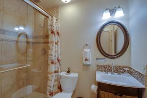 a bathroom with a toilet and a sink and a mirror at Cottage of Course - Permit #3092 in Estes Park +27 photos