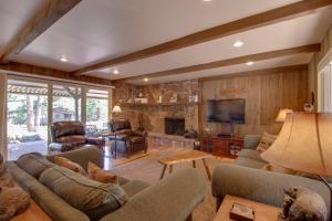 a living room with couches and a tv and a fireplace at Cottage of Course - Permit #3092 in Estes Park