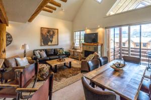 a living room with a couch and a table at Saddle Ridge I2 in Big Sky