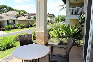 a patio with a table and two chairs and a table and a table and chairs at Vacation Home in Ko Olina Resort in Kapolei
