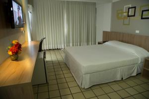 Monza Palace Hotel tesisinde bir odada yatak veya yataklar