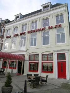 a red brick building with a sign on the side of it at Hotel Bonaventure in Vlissingen