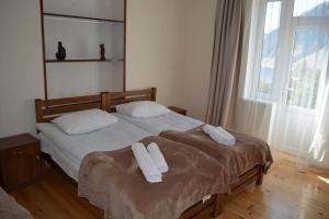 a bedroom with two beds with towels on them at Ekaterine Guest House in Stepantsminda