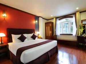 a bedroom with a large bed and a window at Asian Ruby Boutique Hotel Bùi Thị Xuân in Ho Chi Minh City