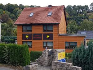 an orange house with a red roof at Pension am Sonnenhof in Schmalkalden