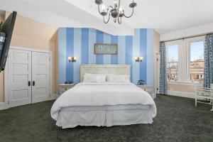 a bedroom with a bed with blue and white stripes at Patterson Inn in Denver