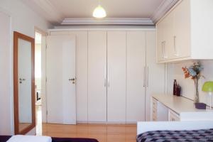a kitchen with white cabinets and a counter top at FamilyHome in Florianópolis