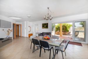 a dining room and living room with a table and chairs at Appartamento del Cardellini in Santa Caterina