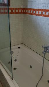 La salle de bains est pourvue d'une baignoire et d'une douche avec un robinet. dans l'établissement Casa Magda, à Vigo 53 autres photos