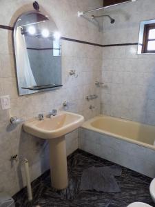 a bathroom with a sink and a tub at Meridiano68 Apartment in Ushuaia +17 photos
