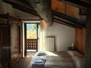 a bedroom with a large bed and a window at Hameau De Jadis in Pré-Saint-Didier
