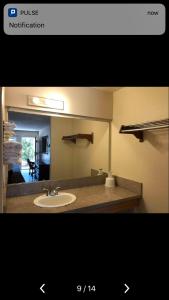a bathroom with a sink and a mirror at Sand Piper Motel - Los Angeles in Los Angeles