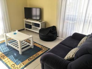 a living room with a couch and a table and a tv at Mira Maia Apartment in Maia