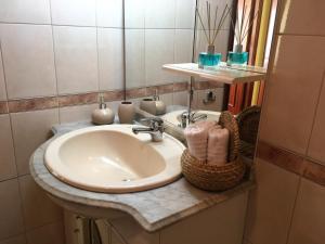 a bathroom with a sink and a mirror at Mira Maia Apartment in Maia +19 photos